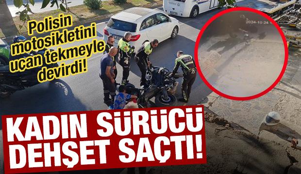 Çılgına dönen kadın, polisin motosikletini tekmeleyip devirdi