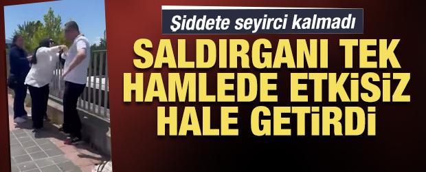 Yere d&uuml;ş&uuml;rd&uuml;ğ&uuml; kadının boğazını sıkan saldırganı yoldan ge&ccedil;en kadın iterek durdurdu