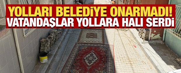 İzmir'de kazılan yolları belediye onarmadı! Vatandaşlar yollara halı serdi
